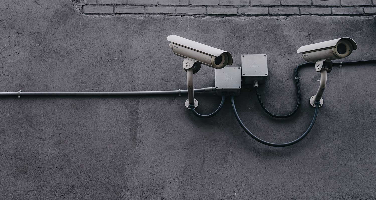 Two CCTV surveillance cameras mounted on the wall